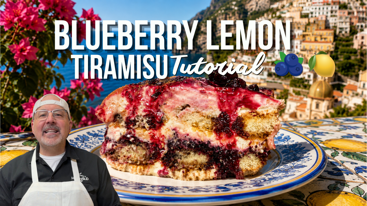 A large slice of blueberry lemon tiramisu cake on a blue and white patterned plate, set against a scenic coastal background with a man in an apron visible in the lower-left corner. Large text reads 'BLUEBERRY LEMON TIRAMISU Tutorial' with small blueberry and lemon icons.