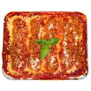 A family size tray of Lasagna Bolognese with layers of pasta and sauce, garnished with a basil leaf.